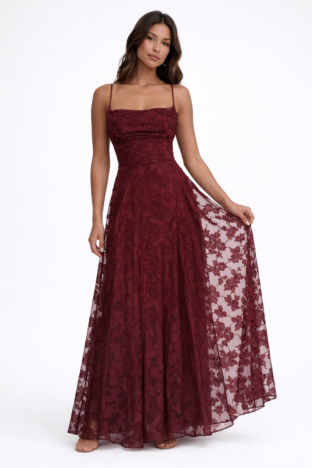 Woman wearing a burgundy lace dress for special occasions on a white background