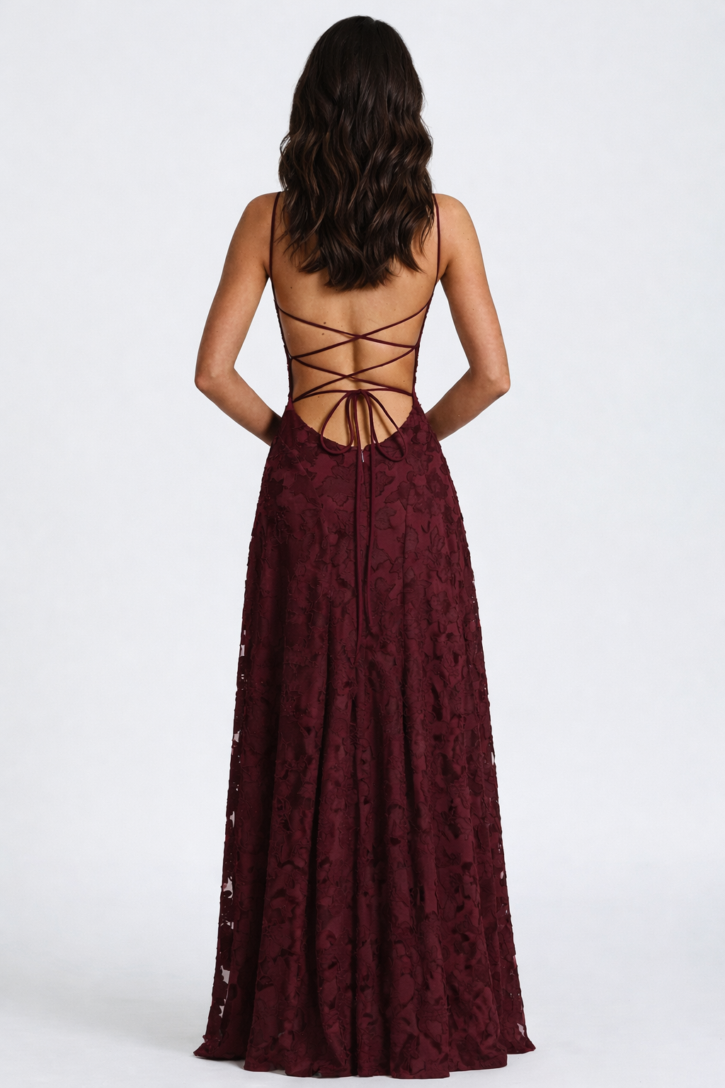 Burgundy lace dress with open back on a white background