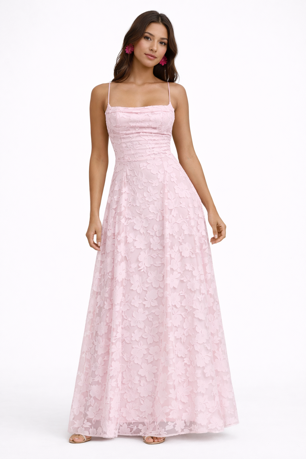 Woman wearing a pink lace dress for special occasions on a white background